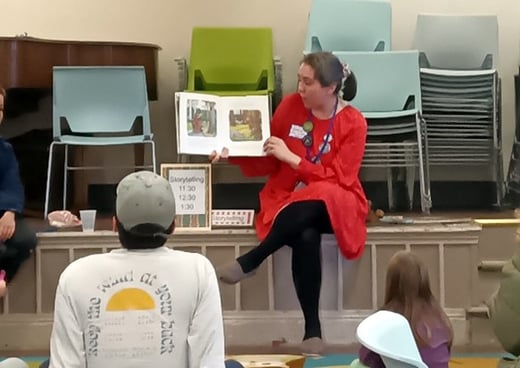 Photo of Grace Foster reading to an audience
