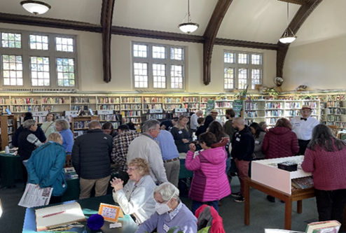 Photo of a large crowd gathered inside Falls of Schuylkill Library