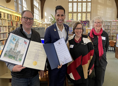 Photo of Left: Josh Cohen, Chief of Staff Curtis Jones Office; State Representative Tarik Khan; Sandy Thompson Free Library of Philadelphia; and Martha Fuller, President of the Friends of Falls of Schuylkill Library holding up historical citations