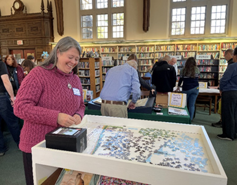 Photo of white woman assembling a puzzle